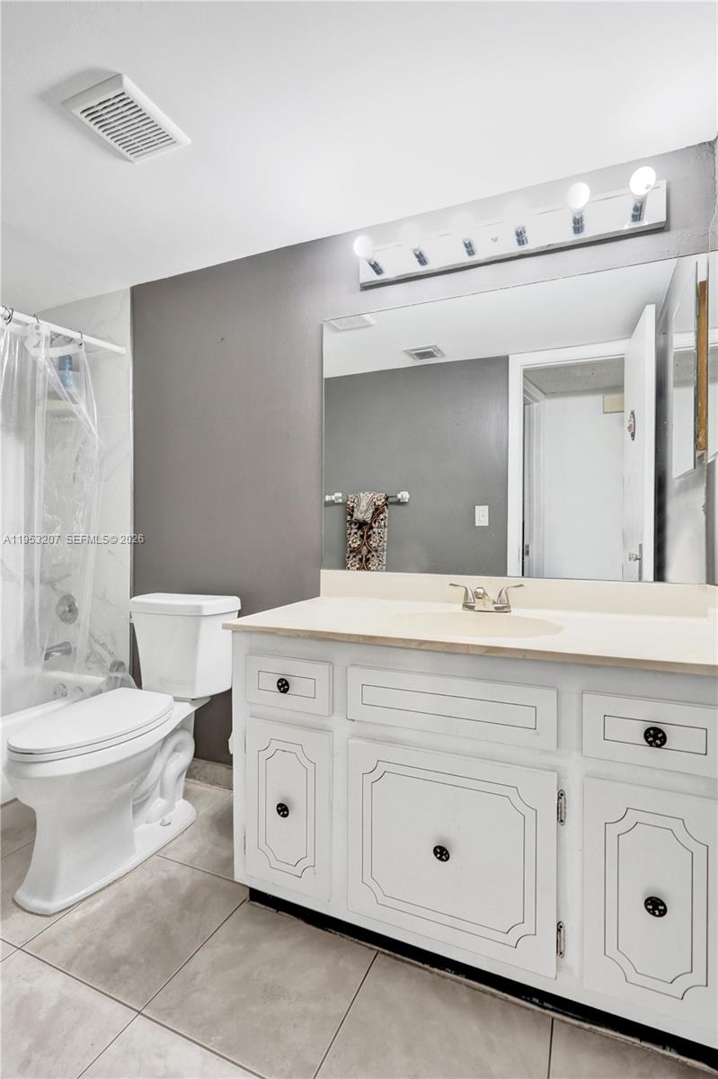 3511 Inverrary Drive, Unit 107 Lauderhill, FL 33319 - Photo 15 of 47 a bathroom with a double vanity sink mirror and toilet