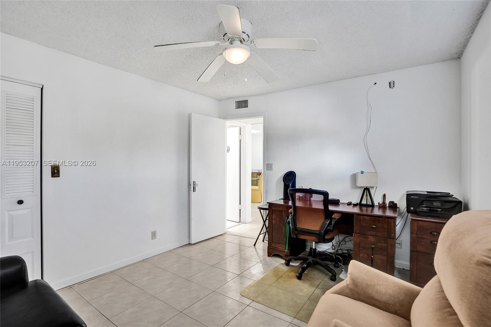 3511 Inverrary Drive, Unit 107 Lauderhill, FL 33319 - Photo 16 of 47 a view of a workspace with furniture and a ceiling fan