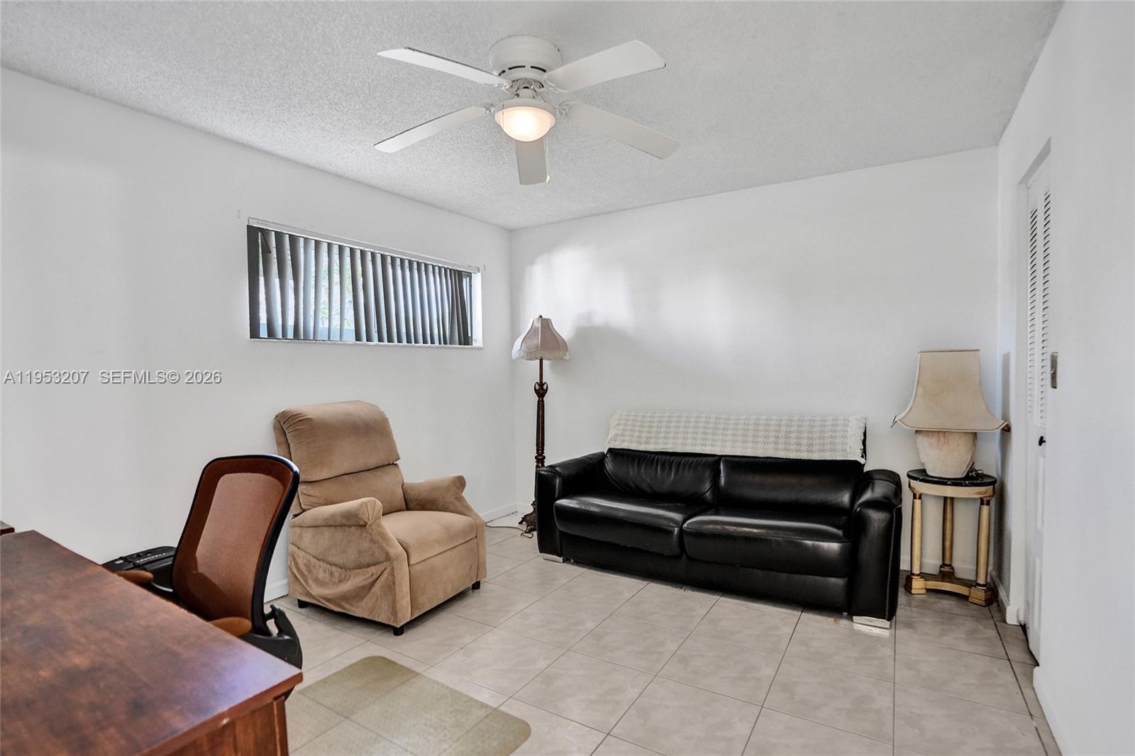 3511 Inverrary Drive, Unit 107 Lauderhill, FL 33319 - Photo 19 of 47 a living room with furniture and a ceiling fan
