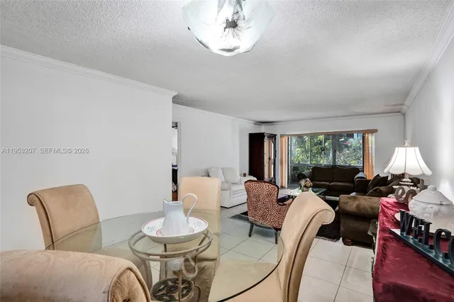 a living room with furniture a window and a dining table