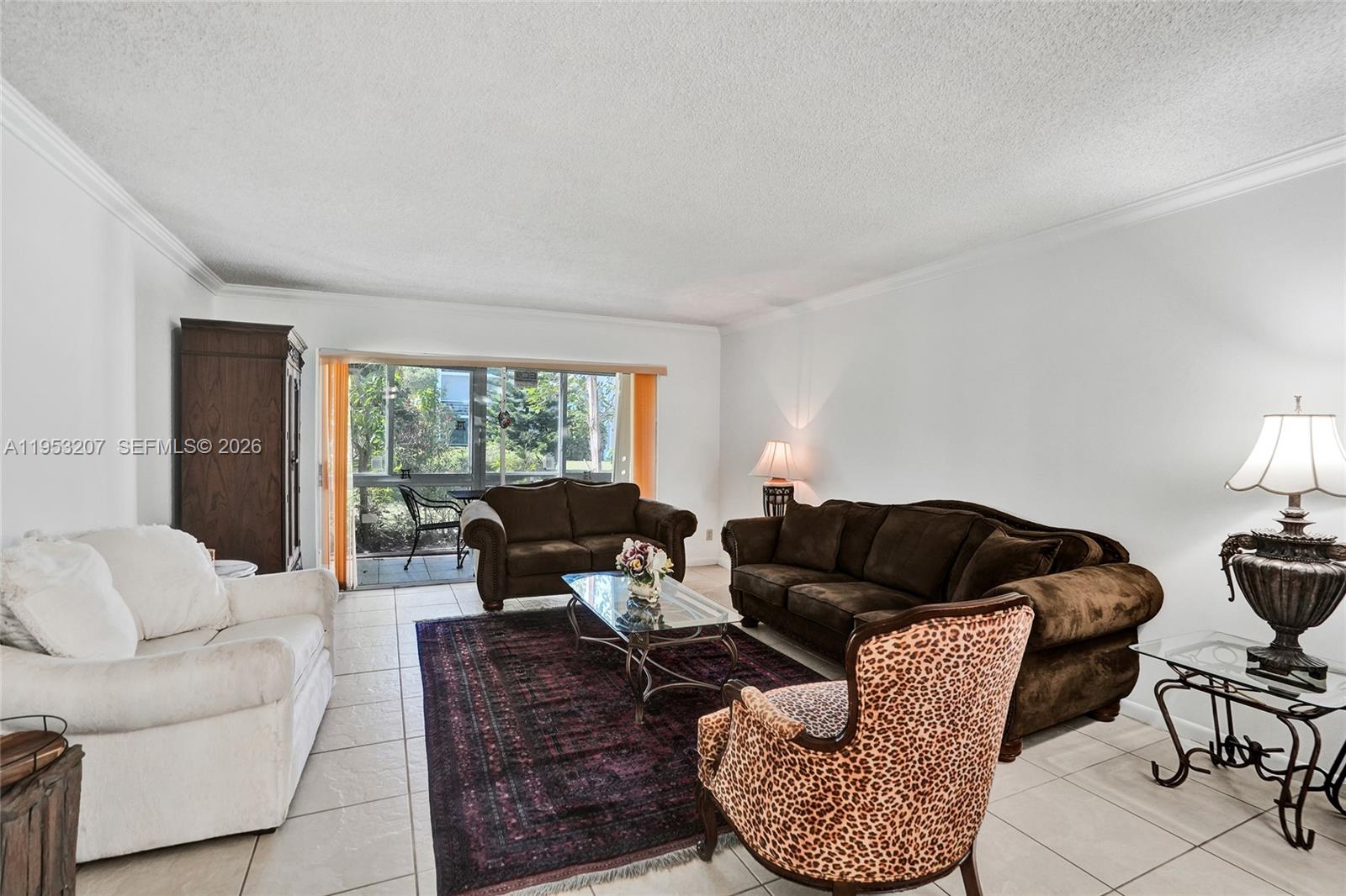 3511 Inverrary Drive, Unit 107 Lauderhill, FL 33319 - Photo 23 of 47 a living room with furniture and a large window