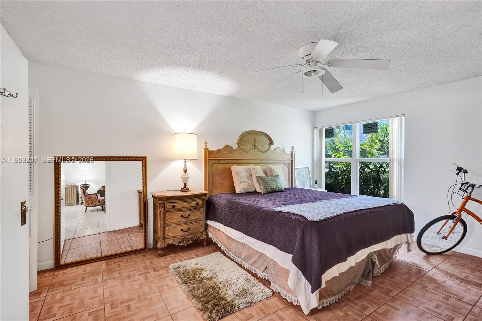 3511 Inverrary Drive, Unit 107 Lauderhill, FL 33319 - Photo 27 of 47 a bedroom with a bed and a chandelier