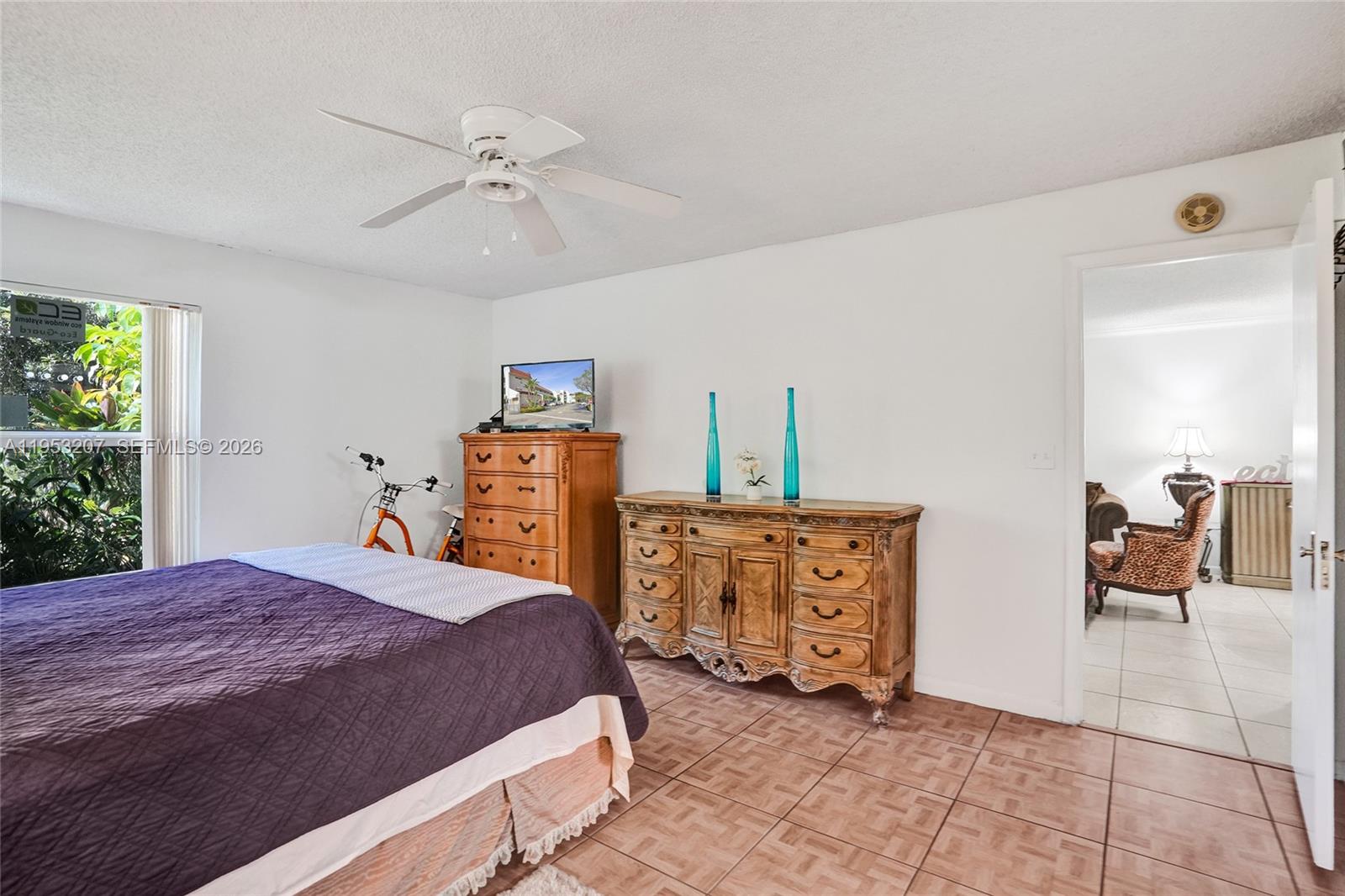 3511 Inverrary Drive, Unit 107 Lauderhill, FL 33319 - Photo 28 of 47 a bedroom with a bed and a chandelier
