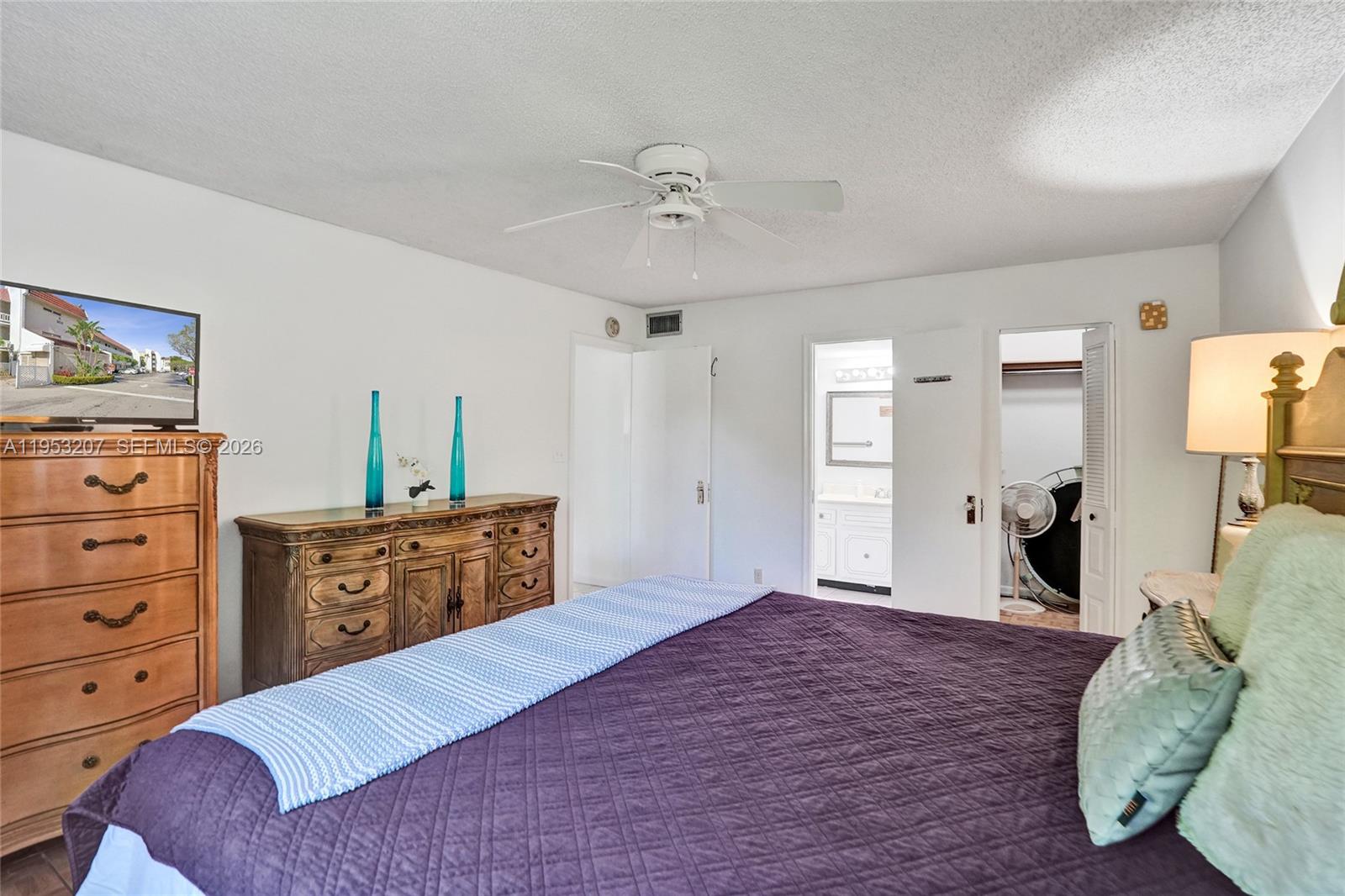 3511 Inverrary Drive, Unit 107 Lauderhill, FL 33319 - Photo 32 of 47 a bedroom with a bed and a dresser