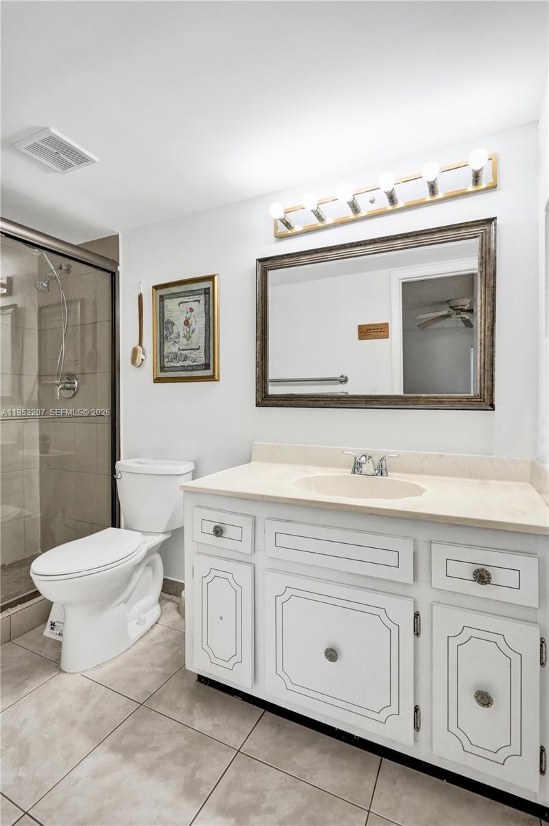 3511 Inverrary Drive, Unit 107 Lauderhill, FL 33319 - Photo 34 of 47 a bathroom with a toilet sink and mirror