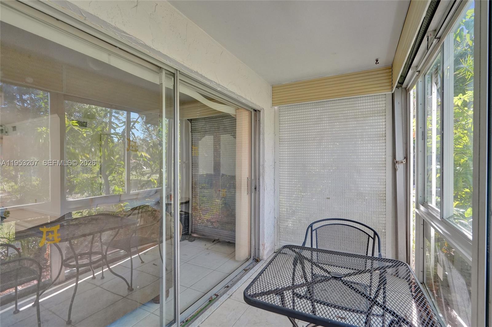 3511 Inverrary Drive, Unit 107 Lauderhill, FL 33319 - Photo 36 of 47 a picture of a glass door and chair