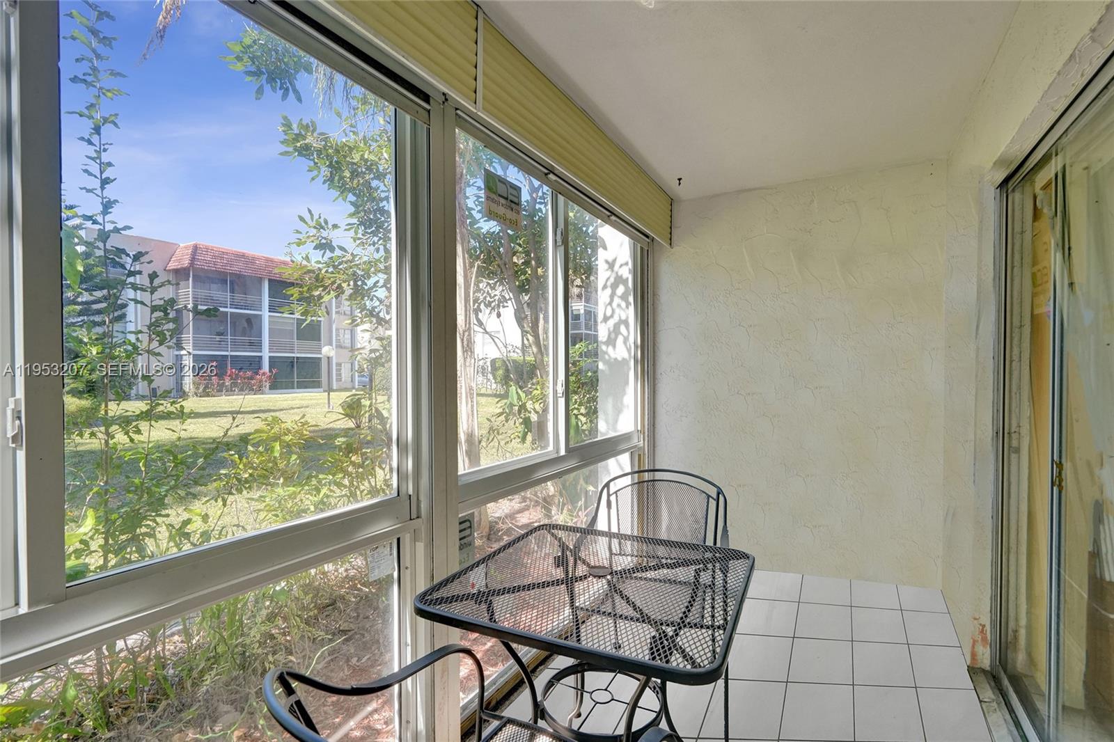 3511 Inverrary Drive, Unit 107 Lauderhill, FL 33319 - Photo 37 of 47 a view of a room with furniture and floor to ceiling window