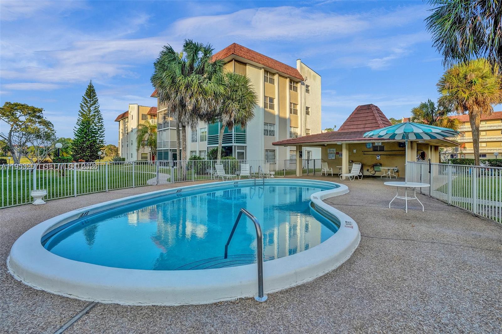 3511 Inverrary Drive, Unit 107 Lauderhill, FL 33319 - Photo 39 of 47 a view of swimming pool with a garden and trees