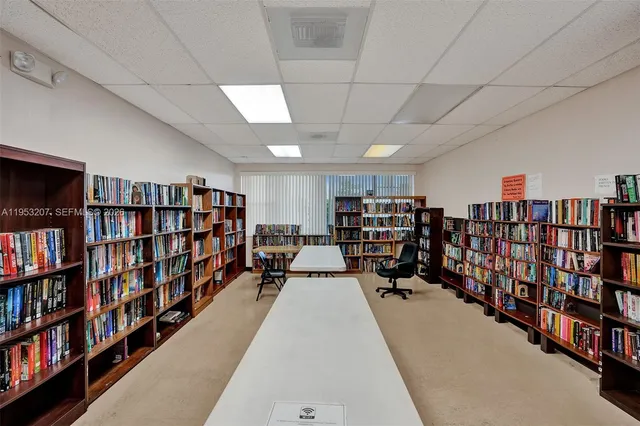 a hallway with a book shelf and a book shelf