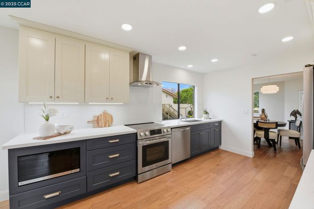 a kitchen with stainless steel appliances granite countertop a stove and a sink