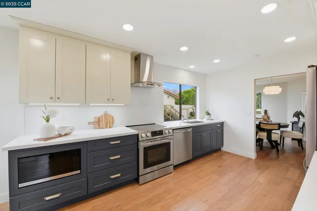 a kitchen with stainless steel appliances granite countertop a stove and a sink