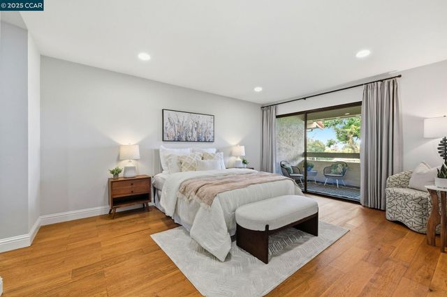 a spacious bedroom with a bed a couch and a window