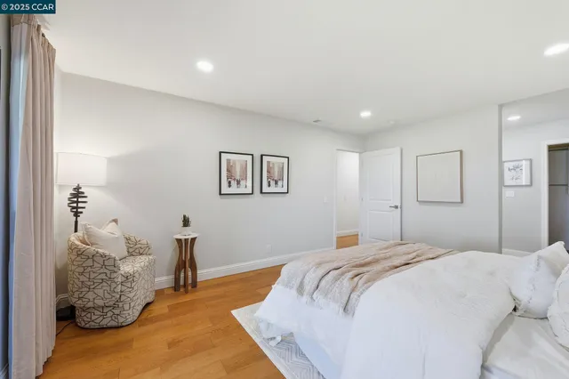 a bedroom with a large bed and a chandelier