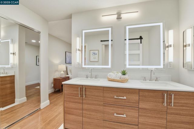 a bathroom with a granite countertop sink and a mirror