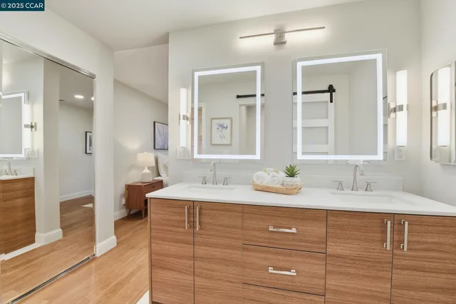 a bathroom with a granite countertop sink and a mirror