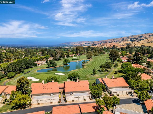an aerial view of residential houses with outdoor space and street view