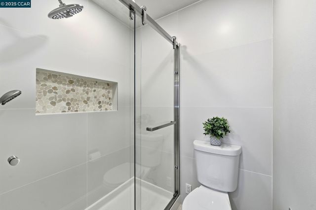 a white toilet sitting next to a bath tub