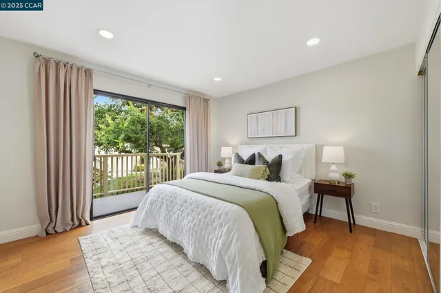 a bedroom with a large bed and a large window