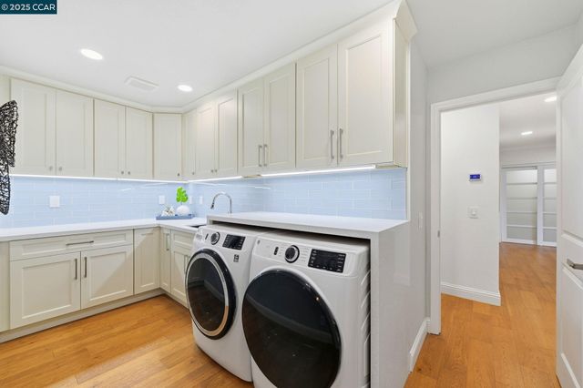 a utility room with sink dryer and washer