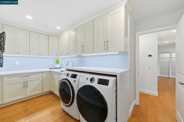 a utility room with sink dryer and washer