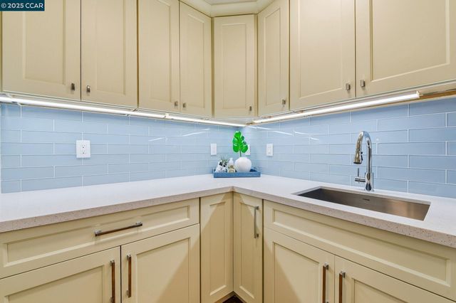 a kitchen with a sink and cabinets