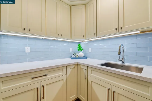 a kitchen with a sink and cabinets
