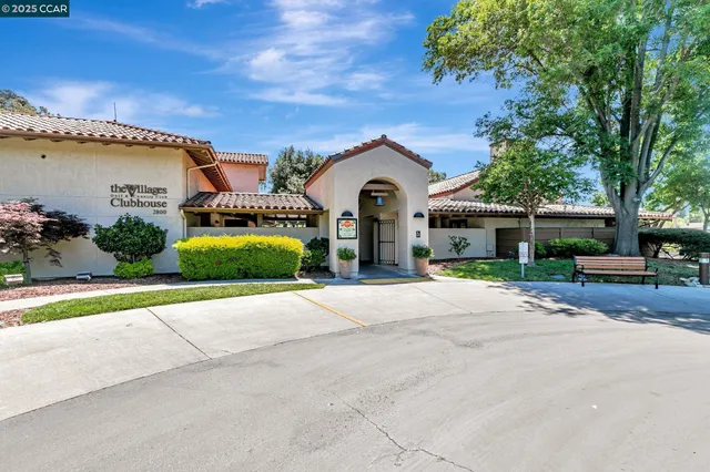 a front view of a house with a garden and trees