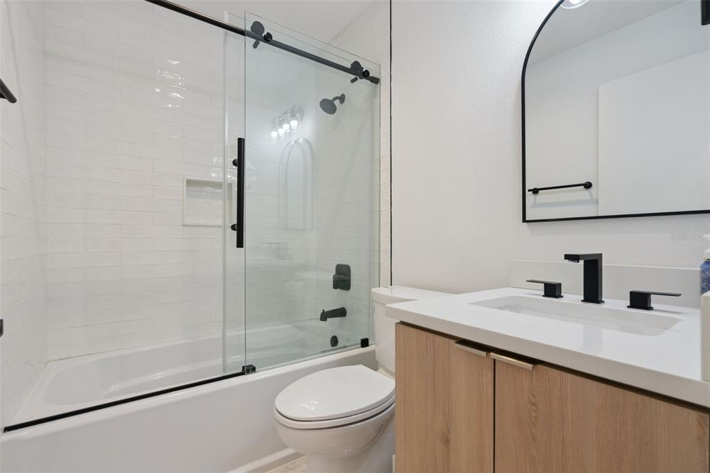908 Croton Road Celebration, FL 34747 - Photo 37 of 86 a bathroom with a granite countertop sink toilet and shower