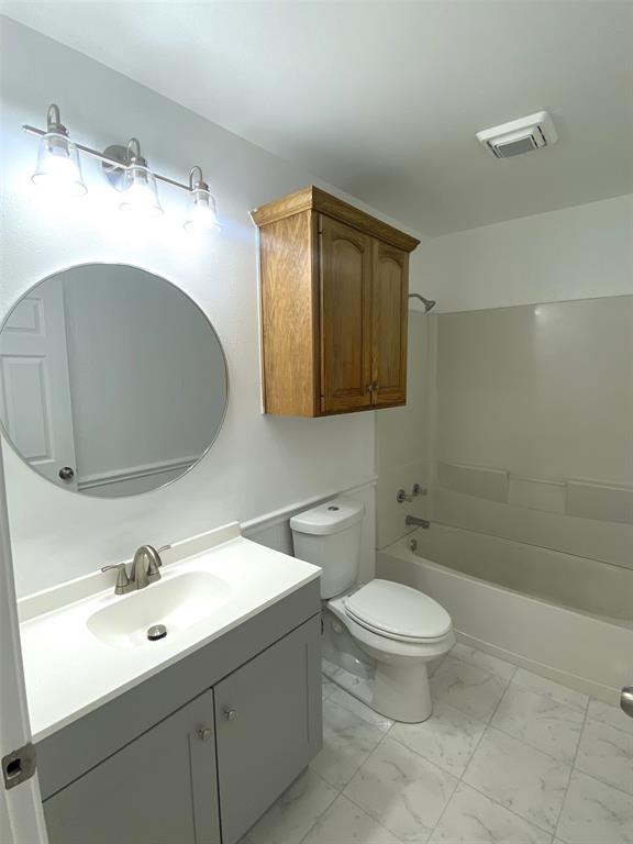 505 Red Springs Avenue Mount Pleasant, TX 75455 - Photo 8 of 9 Bathroom with marble finish floors, vanity, and shower combination