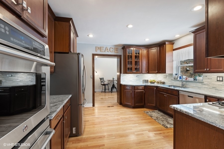 442 Kent Road Riverside, IL 60546 - Photo 15 of 45 a large kitchen with stainless steel appliances granite countertop a stove refrigerator and cabinets