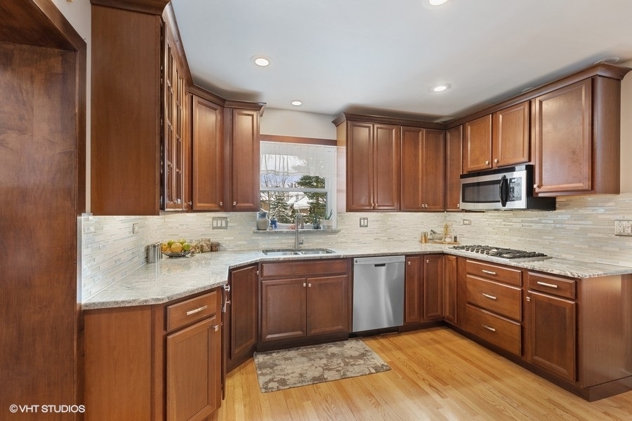442 Kent Road Riverside, IL 60546 - Photo 18 of 45 a kitchen with a sink stove and cabinets