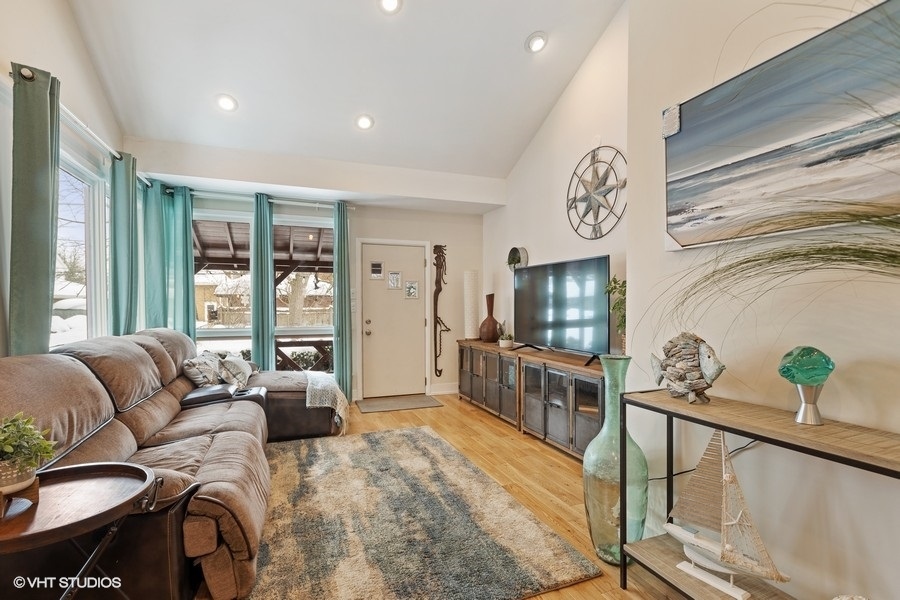 442 Kent Road Riverside, IL 60546 - Photo 22 of 45 a living room with furniture a flat screen tv and a floor to ceiling window