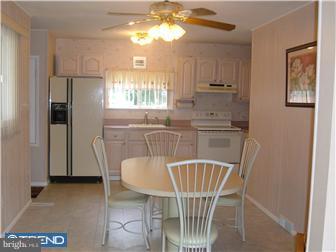 626 Polk Street Riverside, NJ 08075 - Photo 6 of 12 a kitchen with stainless steel appliances granite countertop a dining table chairs cabinets a sink and a window