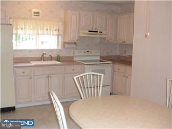 626 Polk Street Riverside, NJ 08075 - Photo 7 of 12 a kitchen with stainless steel appliances kitchen island granite countertop a sink a stove a dining table and chairs
