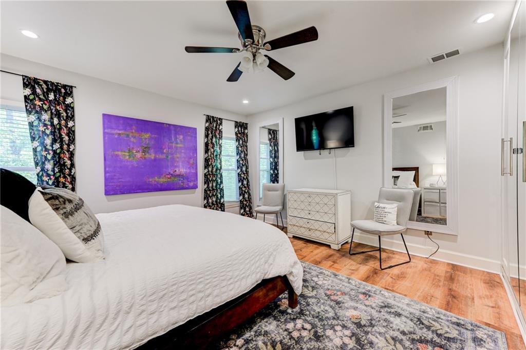 2075 Clairmeade Valley Road Northeast Atlanta, GA 30329 - Photo 11 of 51 a spacious bedroom with a bed and a flat screen tv