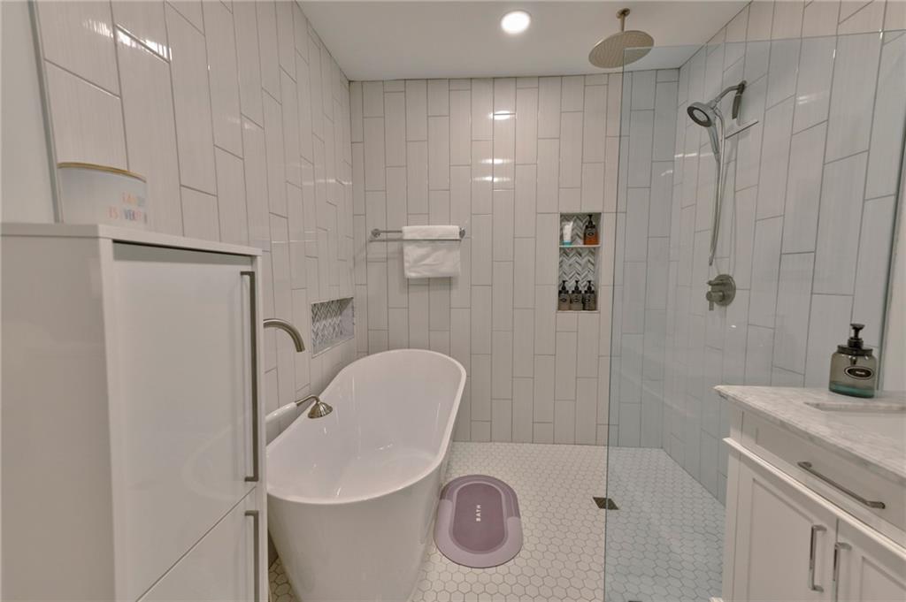 2075 Clairmeade Valley Road Northeast Atlanta, GA 30329 - Photo 12 of 51 a bathroom with a sink a toilet and shower