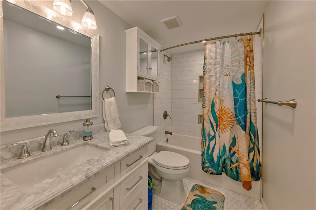 2075 Clairmeade Valley Road Northeast Atlanta, GA 30329 - Photo 14 of 51 a bathroom with a granite countertop sink toilet and shower