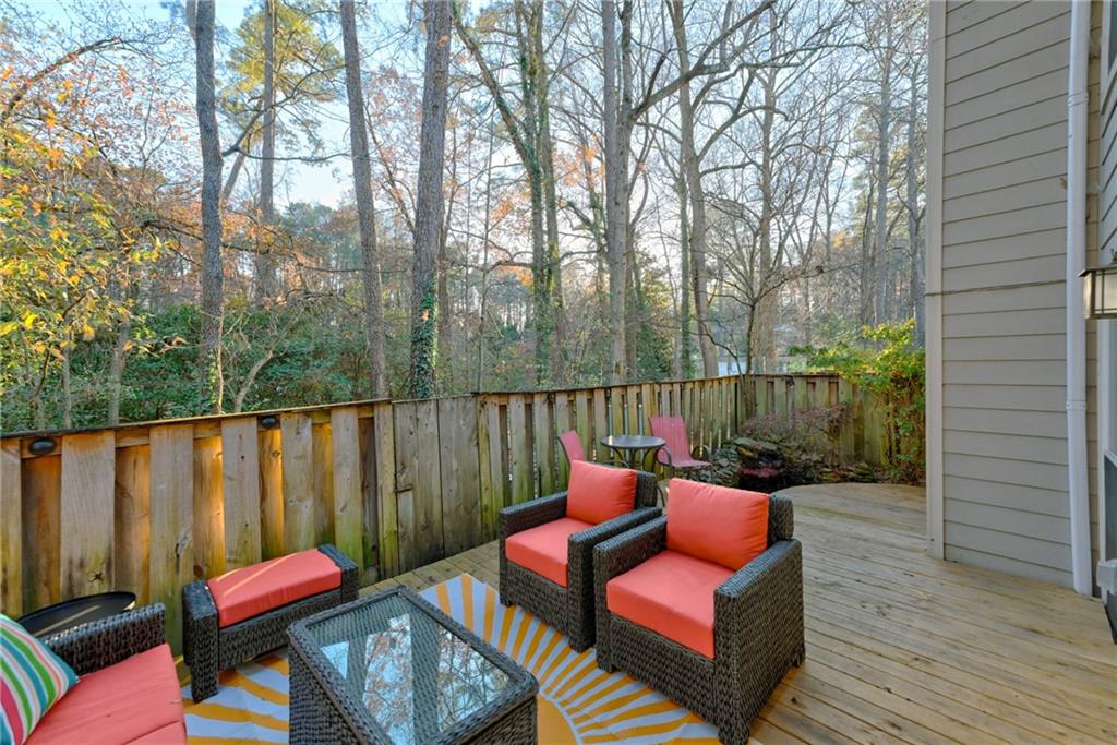 2075 Clairmeade Valley Road Northeast Atlanta, GA 30329 - Photo 21 of 51 a balcony with wooden floor table and chairs