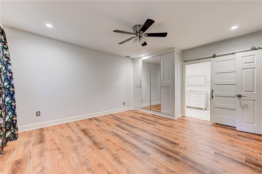 2075 Clairmeade Valley Road Northeast Atlanta, GA 30329 - Photo 46 of 51 a view of empty room with wooden floor and ceiling fan