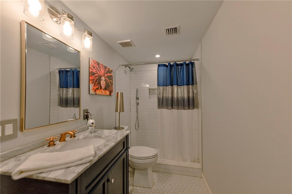 2075 Clairmeade Valley Road Northeast Atlanta, GA 30329 - Photo 8 of 51 a bathroom with a granite countertop sink a toilet and shower