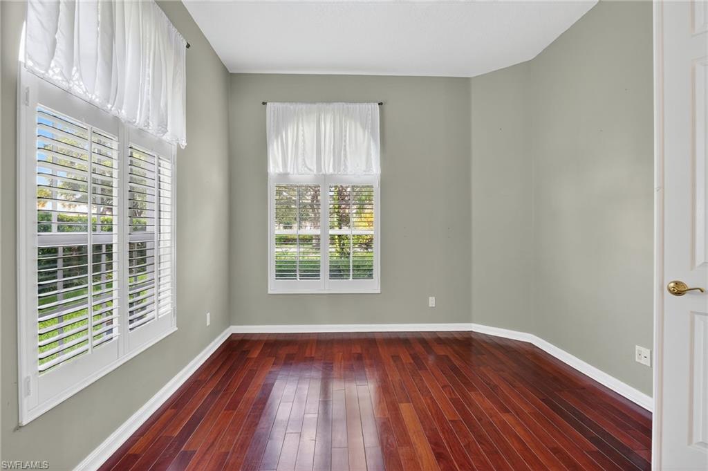 5902 Bermuda Lane Naples, FL 34119 - Photo 19 of 50 a view of an empty room with wooden floor and a window