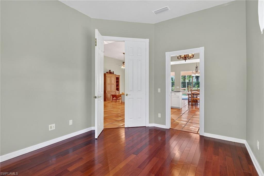 5902 Bermuda Lane Naples, FL 34119 - Photo 20 of 50 an empty room with wooden floor and closet