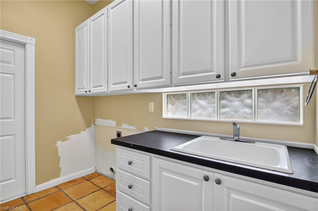 5902 Bermuda Lane Naples, FL 34119 - Photo 27 of 50 a kitchen with a sink and cabinets