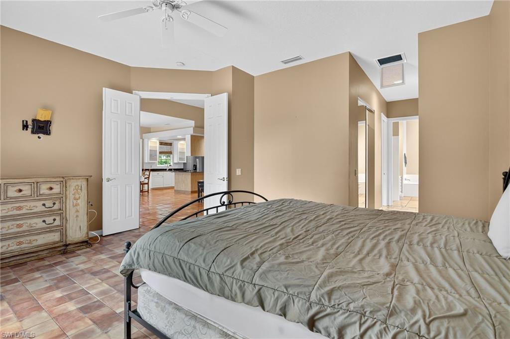 5902 Bermuda Lane Naples, FL 34119 - Photo 30 of 50 a bedroom with a bed and a dresser