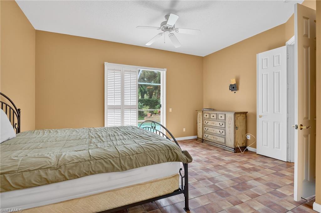 5902 Bermuda Lane Naples, FL 34119 - Photo 31 of 50 a bedroom with a bed dresser and a window