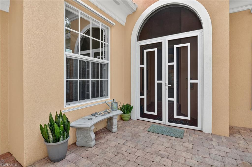 5902 Bermuda Lane Naples, FL 34119 - Photo 4 of 50 a front view of a house with potted plants