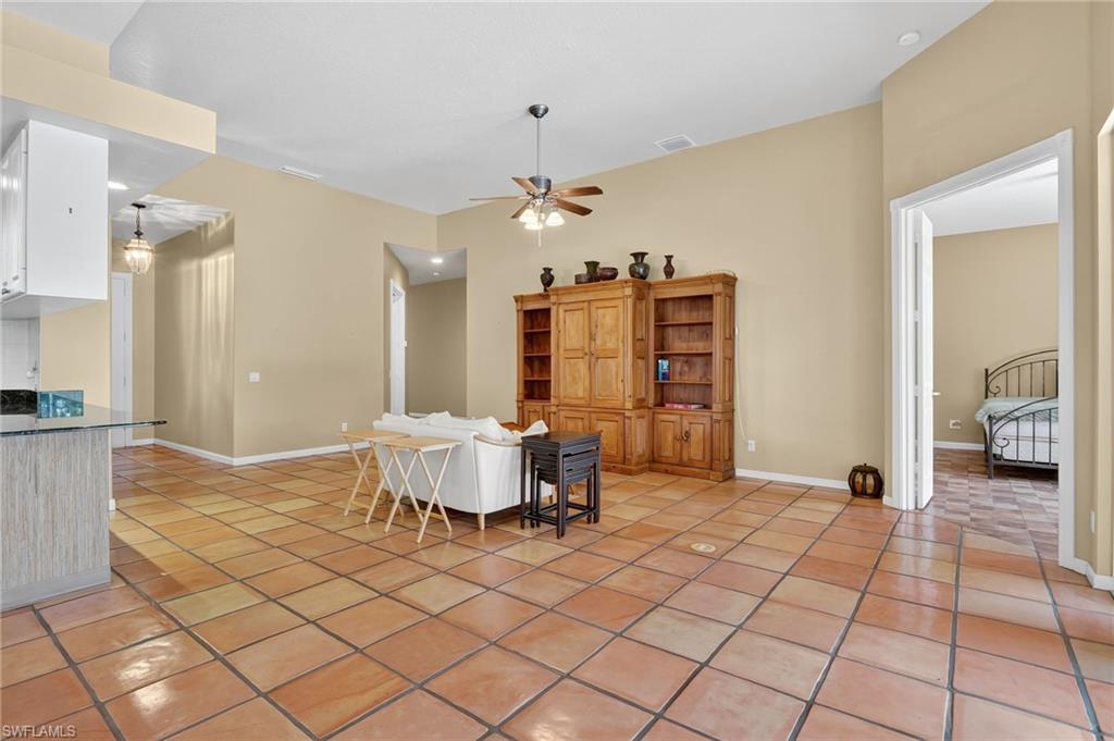5902 Bermuda Lane Naples, FL 34119 - Photo 10 of 50 a spacious bedroom with a bed and a chandelier