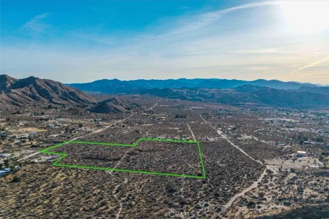 a view of a backyard with wooden fence