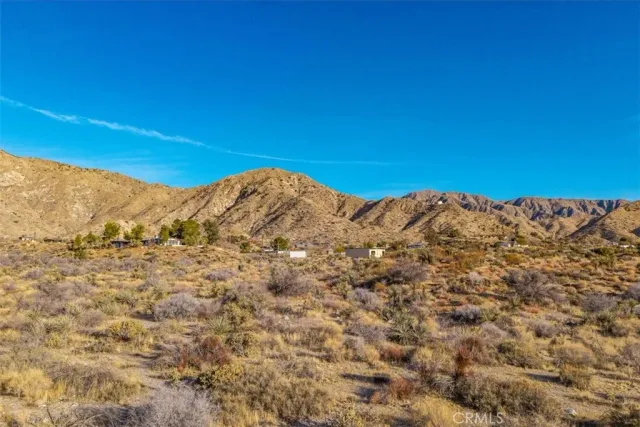 a view of a large mountain with mountains in the background