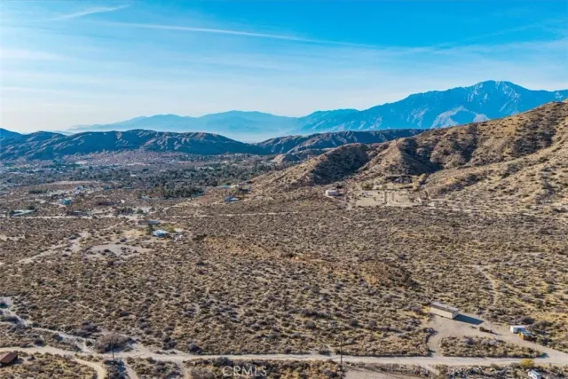 a view of mountain with a forest